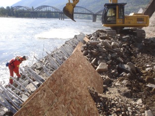 Placing riprap to final road sub-grade